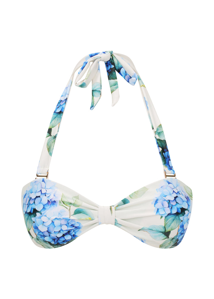 White Fleurs Duo Top in vibrant blue hydrangea floral print with green leaves, with halter neck style with ties and a gathered center, against a white backdrop.