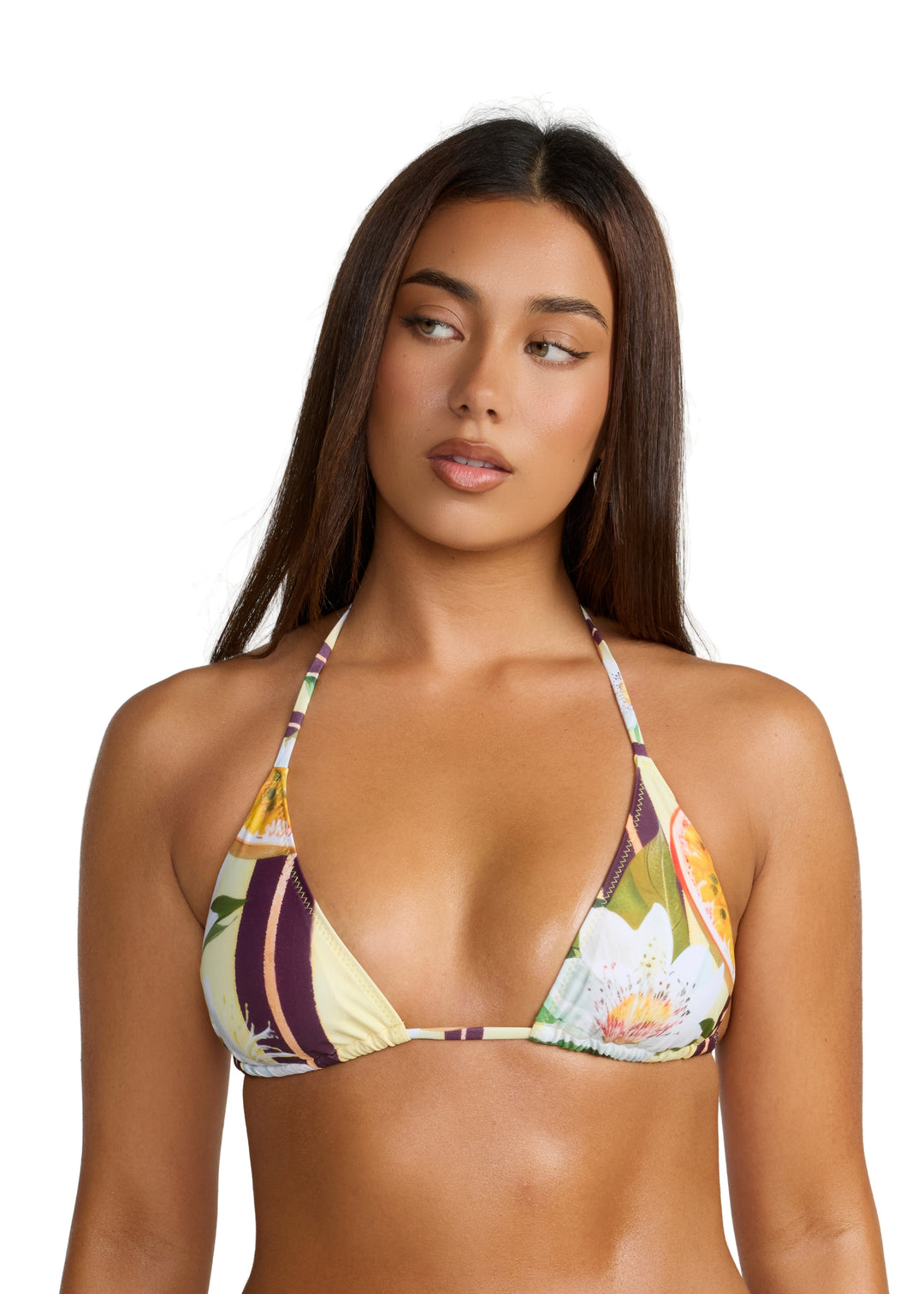 Woman with long black hair glancing right wearing a Passiontini Top classic triangle style bikini top with neck and back ties, in tropical passionfruit and floral print with yellow passionfruit halves, green leaves, and cream background, shown from head to upper midsection on a white backdrop.